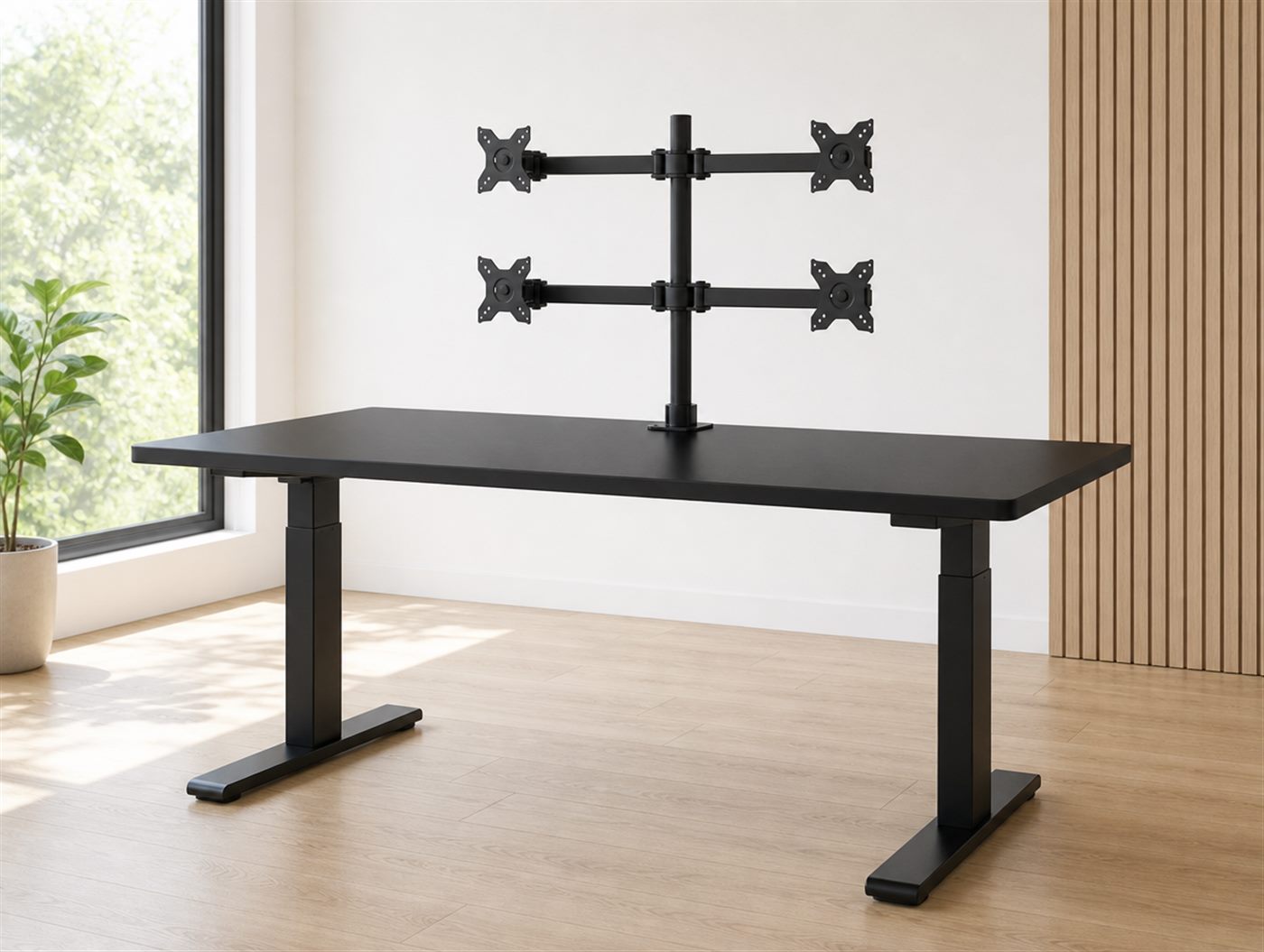 Black sit-stand desk with a quad monitor arm mounted on a central pole